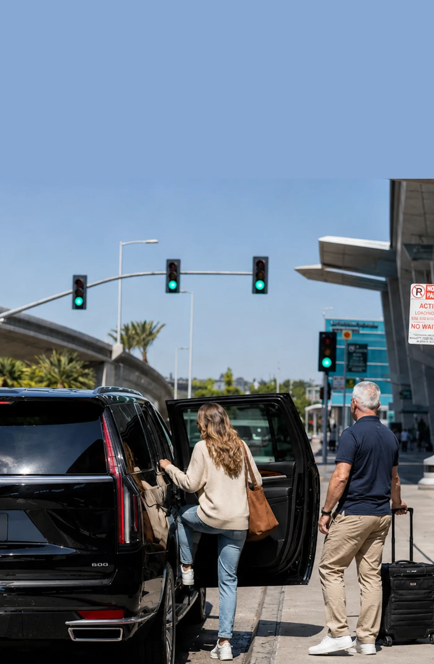 A Celva patient and companion boarding a private SUV at the San Diego airport curbside before the same-day transfer to Mexico